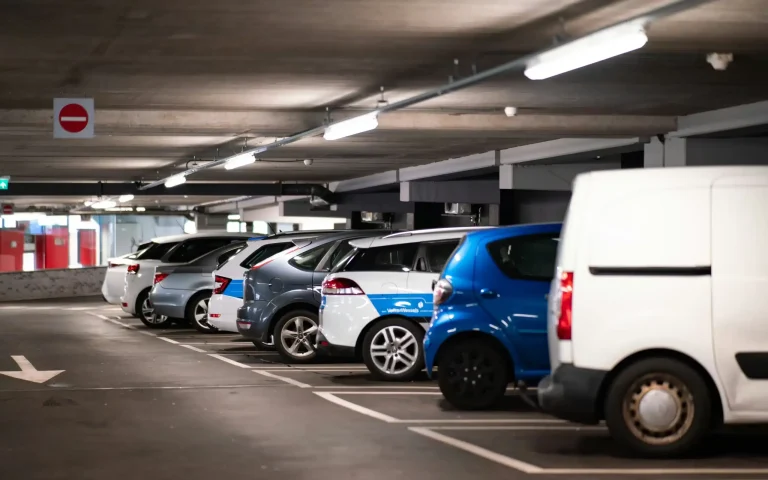 indoor parking space with 8 cars parked next to each other